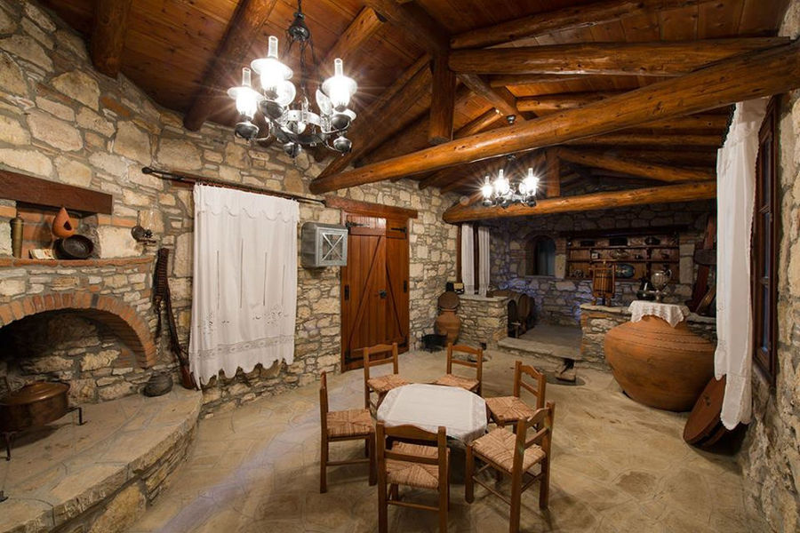 Vakakis Winery stone tasting room with wood ceiling, door and wiindows
